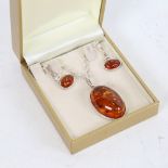 A sterling silver and amber demi-parure, comprising pendant necklace and pair of earrings