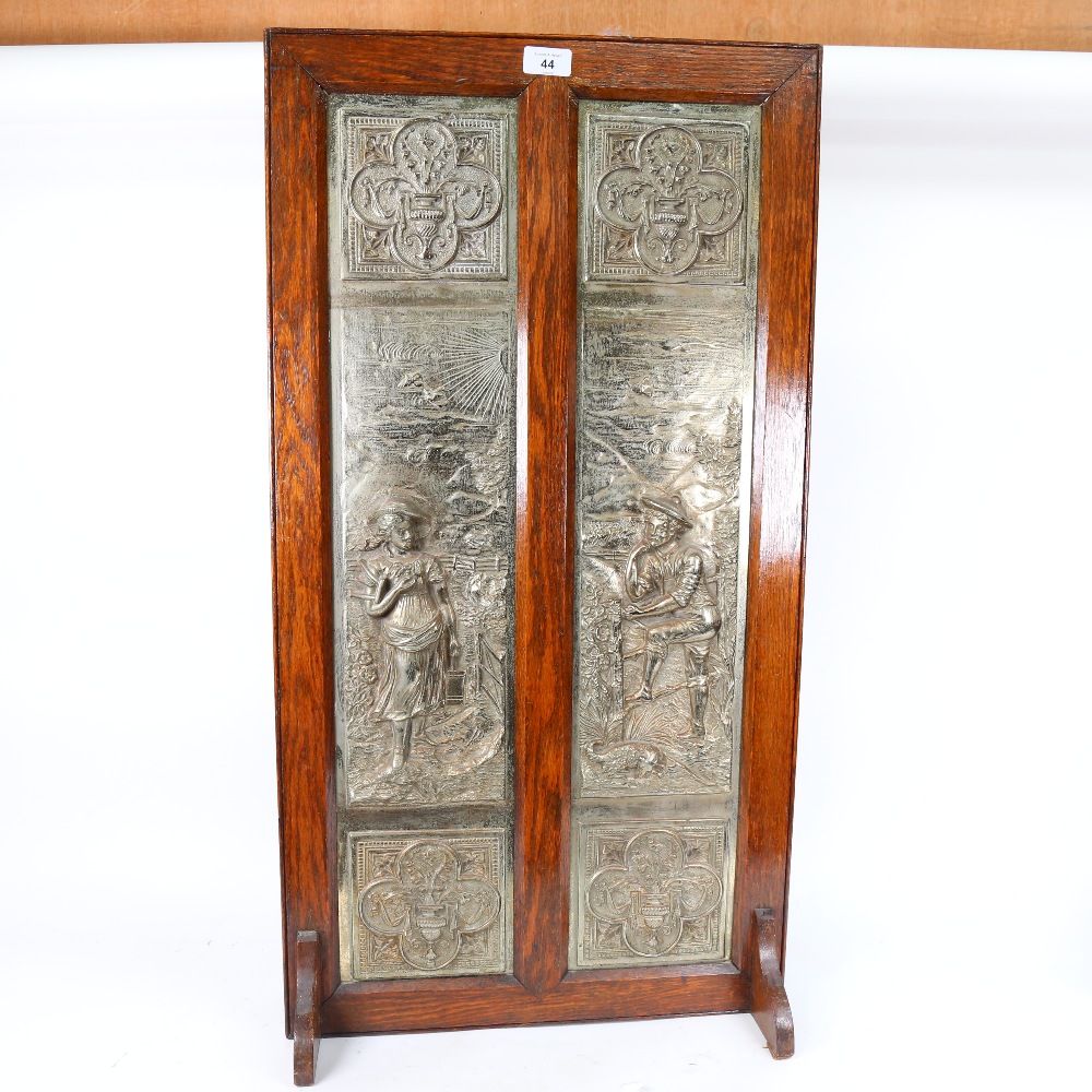 A large Victorian 2-section cast-iron fire screen, relief figural decoration with oak frame, - Image 2 of 2