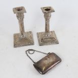 A pair of Victorian silver column table candlesticks, and a George V silver evening purse (3)