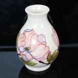 A Moorcroft cream ground pink magnolia vase, height 20cm