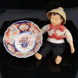 A Japanese hand painted and lacquered doll, and an Imari style bowl, diameter 16cm (2)
