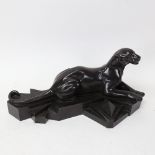 After P Trudeau, an Art Deco style resin sculpture, recumbent panther on geometric base, signed,