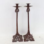A large pair of Arts and Crafts style wrought-iron candlesticks, height 50cm