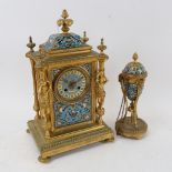 An ornate brass mantel clock, with floral decorated enamelled panels, height 35cm, and matching