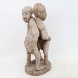 An African Tribal carved hardwood wrestling sculpture, height 40cm