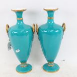 A pair of Royal Worcester turquoise urn vases, height 32cm (1 A/F)