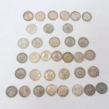 A quantity of British one shilling coins, including some silver, and 1887 Victoria Jubilee head,