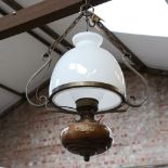 An Antique brass-mounted mahogany ceiling light fitting, with large milk glass shade and clear glass