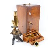 A brass-mounted Leitz student's microscope, with accessories, in mahogany carrying case