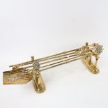 A set of polished brass fire irons on stands, length 67cm, and a toasting fork