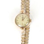 A lady's Vintage 9ct gold Uno mechanical wristwatch, textured silvered dial with gilt Arabic