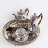 A 4-piece silver plated embossed and engraved tea set, a circular serving tray with pierced edge and