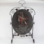 An Art Nouveau painted wrought-iron and copper firescreen, relief embossed ship decoration, H84cm,