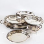 A collection of silver plated serving trays, and entree dishes