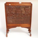 An African Tribal carved hardwood firescreen, figural and Queen Mother decoration, H70cm, W54cm