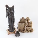 A Chinese red cherry amber Guan Yin figure on fitted base (A/F), and a green soapstone floral