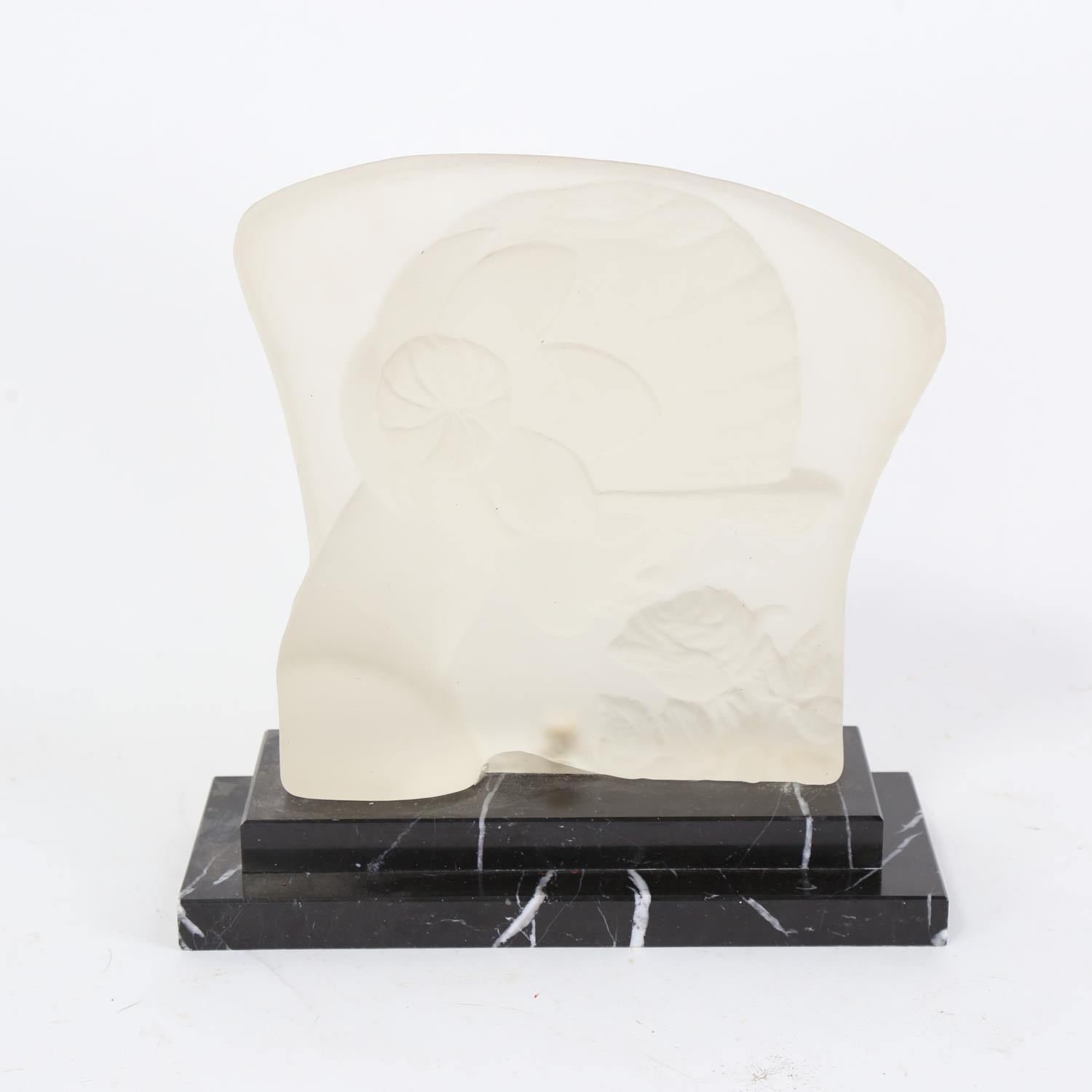 An Art Deco frosted glass sculpture, lady with a rose, unsigned, on stepped veined black marble