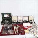 A large collection of plated mixed cutlery, and a cased vanity set