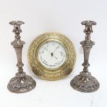 A pair of ornate embossed metal candlesticks, 35cm, and an embossed brass-framed Victorian barometer