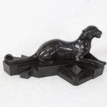 After P Trudeau, an Art Deco style resin sculpture, recumbent panther on geometric base, signed,