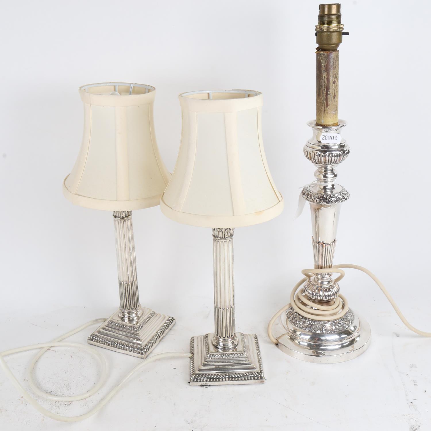 A pair of silver plated Corinthian column candlesticks converted to electric, and a single plated