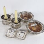 A pair of silver plated wine coasters, with embossed edge, a pair of chamber sticks and snuffers,