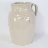 A Doulton Lambeth stoneware pottery 2 and 1/2 gallon measure flagon, height 37cm