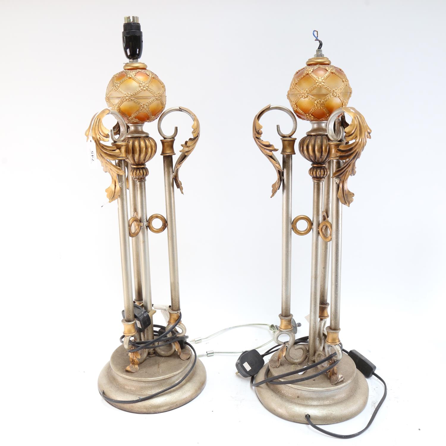 A pair of silvered and gold painted Renaissance style table lamps, height excluding fitting 60cm