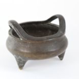 A Chinese polished bronze tripod censer, engraved figural decoration, with 6 character mark on base,