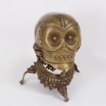 A Tibetan Buddhist cast-brass ritual Kapala/skull cup, with vajra and tripod base, overall height