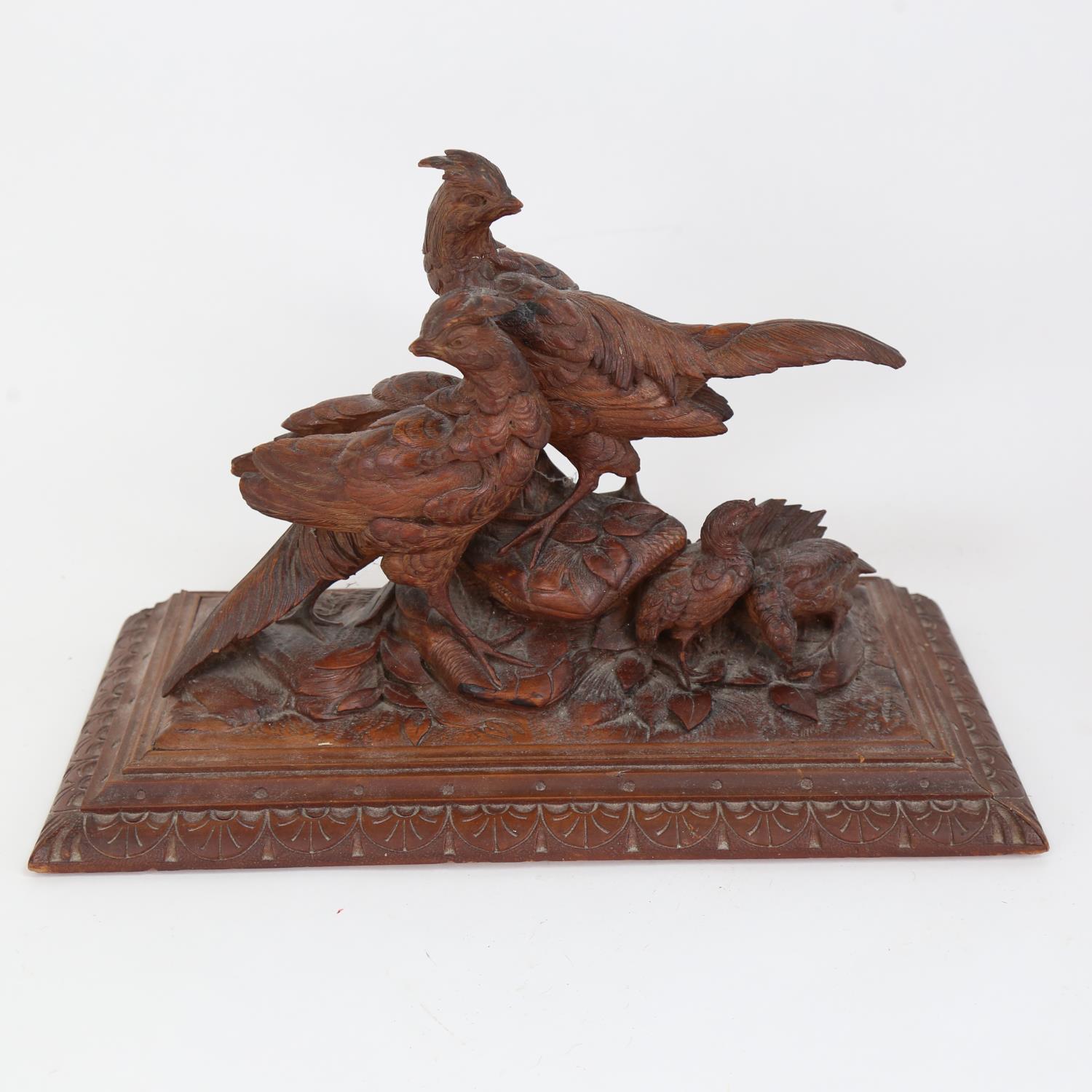 A German Black Forest carved oak pheasant group, base 35cm x 16cm