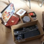 A mixed group of items, including a grey top hat, a leather briefcase, a magnifying glass, prints