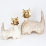 A graduated opposing pair of modernist Studio pottery cats, with gilded faces, indistinctly