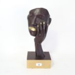 A modernist patinated brass sculpture, face and hand, unsigned, overall height 40cm