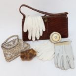 A leather handbag, an evening purse, a compact, gloves etc