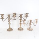 A pair of silver plate on copper 2-branch candelabras, and another (3)