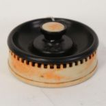 An Art Deco bakelite Roxon Roanoid smoker's companion match striker, diameter 13cm