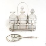 A silver plated 3-bottle decanter stand with bottles, and a Art Deco style silver-backed dressing