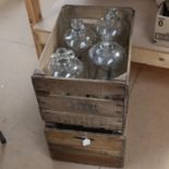 2 Vintage pine bottle crates, and 4 clear glass demijohns