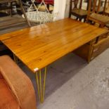 A rectangular pine plank-top kitchen table, on hairpin legs, L149cm, H75cm, D88cm