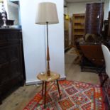 A mid-century standard lamp with integrated shelf, on tripod legs, height including shade 135cm