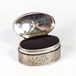 A George III silver pillbox, oval form with engraved floral decoration and red foiled inner lid,