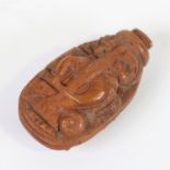 An 18th century coquilla nut snuff bottle, relief carved allover (stopper missing), length 5.5cm