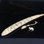 A marine ivory Cribbage marker, early 20th century, length 33cm, together with an ornate carved bone