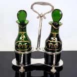 A pair of George V gilded green glass oil and vinegar bottles, on silver stand, hallmarks