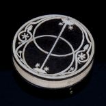 An Arts and Crafts circular ebony and ivory box, with fretwork inlaid lid, diameter 6.5cm