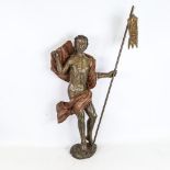 A carved and painted wood religious figure carrying a pennant, probably 18th century, height 57cm