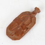 An 18th century coquilla nut snuff bottle, relief carved allover with musical instruments and