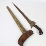 A Malayan Kris knife, with carved horn handle and white metal scabbard, overall length 52cm