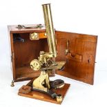 A Victorian brass-mounted monocular student's microscope, in original mahogany case, with spare